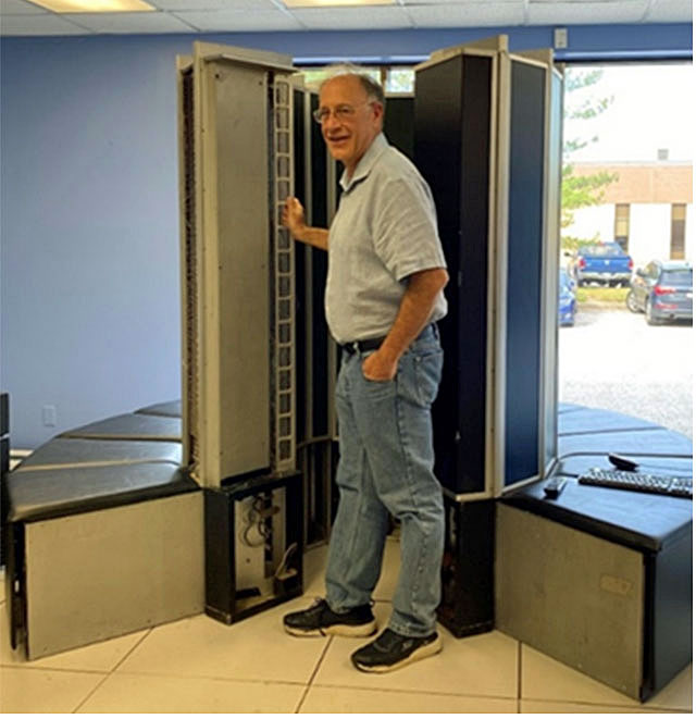 Bob Roswell with Cray-I supercomputer at System Source Museum